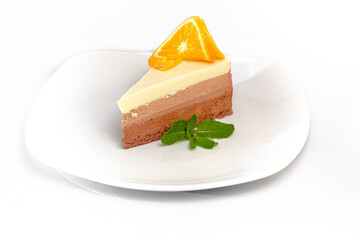 A piece of cake Three chocolates: white, milk and bitter chocolate is on a plate