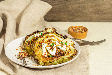 Homemade vegan cabbage steaks with herbs, spices, and sauce. Healthy food ready to eat