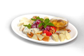 Cheese plate: Parmesan, chiller, Roquefort and other cheeses, next to grapes, honey, strawberries