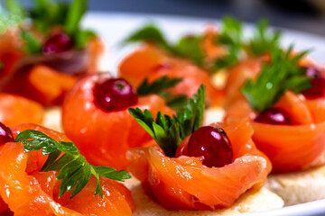 Canapes with lightly salted salmon and lingonberries