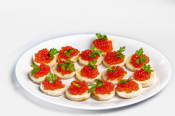 Canapes with salmon caviar and parsley