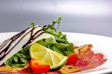 Beef carpaccio with parmesan, lime and arugula