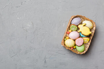 Multi colors Easter eggs in the woven basket on colored background . Pastel color Easter eggs. holiday concept with copy space