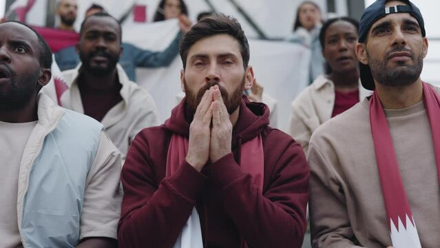 Man sitting on tribune and feeling worry during soccer game