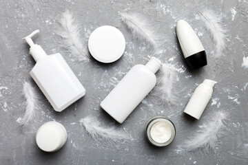 Spa cosmetic product, cream jar, branding mock up, top view with feathers background. Flat lay