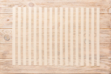 Top view of light tablecloth for food on wooden background. Empty space for your design