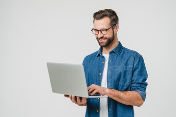 Successful caucasian young man student freelancer using laptop, watching webinars, working remotely, e-learning e-commerce online isolated in white background - obrazy, fototapety, plakaty