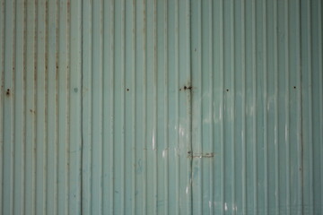 The old green galvanize fence was put together in pieces.