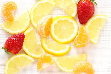 Fototapeta na wymiar Lemon, mandarin, strawberry on table, fruits background