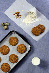 Cookies on the baking tray with cook environment.Top view.