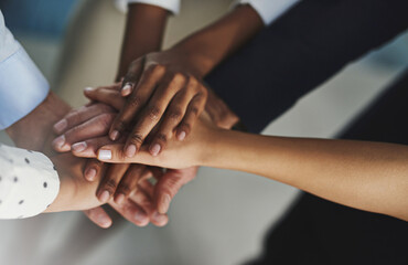 Obraz premium On three.... High angle shot of a group of unrecognizable coworkers hands in a huddle.