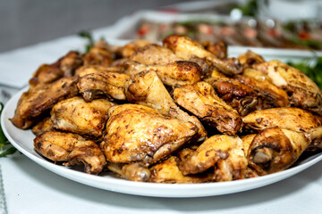 Golden brown baked chicken thighs served on a round white platter
