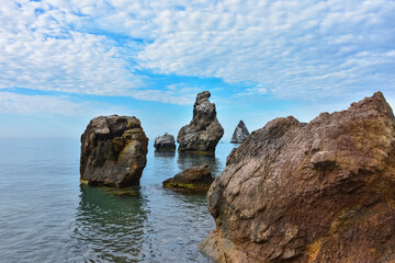 Fototapeta na wymiar rocky shore of Black Sea, landscape with rocks on seashore, rocks sticking out of sea