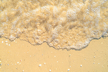 Sand with stones and sea water top view background