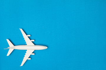 Airplane model. White plane on blue background. Travel vacation concept. Summer background. Flat...