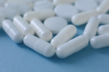 Close up white pills on blue background