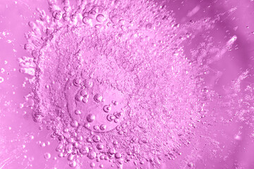 Thick ice with frozen air bubbles. Pink colored background