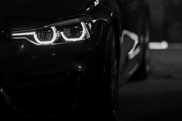 Modern luxury car close-up. Concept of expensive, sports auto. Headlight lamp of new cars, copy...