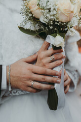 bride and groom holding hands WITH BOUQUET