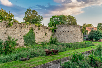 Fototapeta premium Late afternoon view of Tata castle rondel and moat turned into a garden 