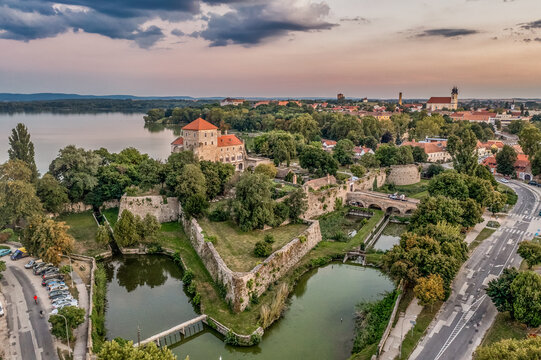 Aerial sunset view over the old lake of Tata with medieval castle surrounded by moat, bastions and walls in Hungary