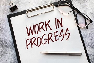 working in progress. a lot of dollar bills on the work table. banknote notepad. text on the page