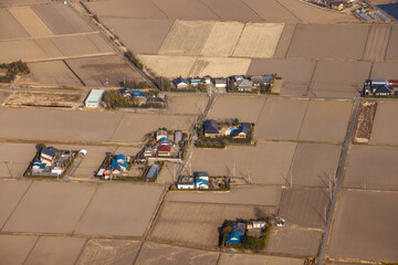 Aerial view of housing plots surrounded by dry farmland