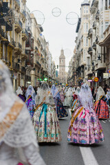 Valencia, spain - March 18, 2022: Falleras parading through the streets of downtown Valencia during the offering to the virgin in Las Fallas, dressed in their traditional costumes.