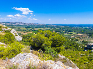 Magnificent landscape with a view of the fields, nature and the Alpilles from the heights of Baux de Provence in Provence in France 
