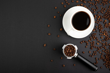 Barista Kit. coffee horn with coffee beans and white cup filter, flatlay on black background with...