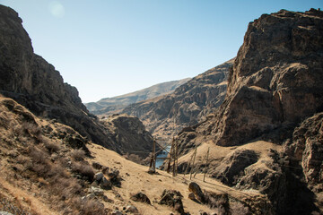 Cave city in Georgia. Ancient architecture. Mountain landscape. Summer day on road.