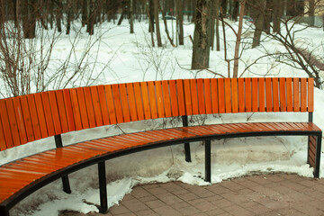 Bench in park in winter. Park furniture. Place to relax.