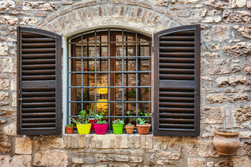Coloured flower pots on a window sill