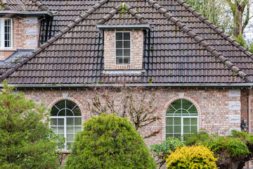 Facade and roof of the luxury house with details of exterior in overcast day in Canada