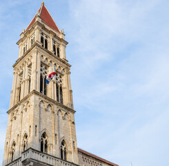 Fototapeta na wymiar Tower of Trogir cathedral vertical view with blue sky