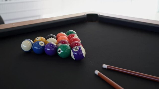 Close-up of a billiard table with balls and cue for gambling indoors. Table game snooker for the entertainment of tourists