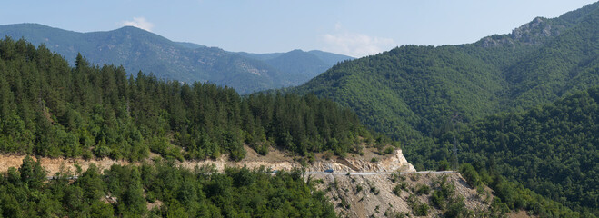 Plakat Rhodopes, are a mountain range in Southeastern Europe. Bulgaria. Panorama. The forest area covers the mountains.