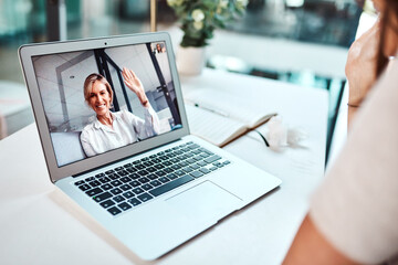 Video conferencing presents countless opportunities to businesses. Shot of a mature woman waving...