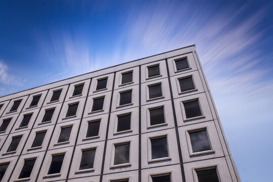 Medium rise office building showing facade of precast concrete exterior panels, windows, daytime, nobody