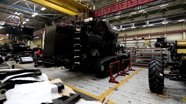 The process of assembling agricultural tractors and harvesters on the conveyor