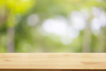 Empty wooden table with garden bokeh background with a country outdoor theme,Template mock up for display of product