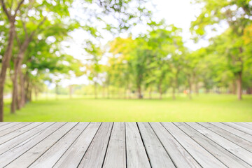 Empty wooden table with garden bokeh for a catering or food background with a country outdoor...