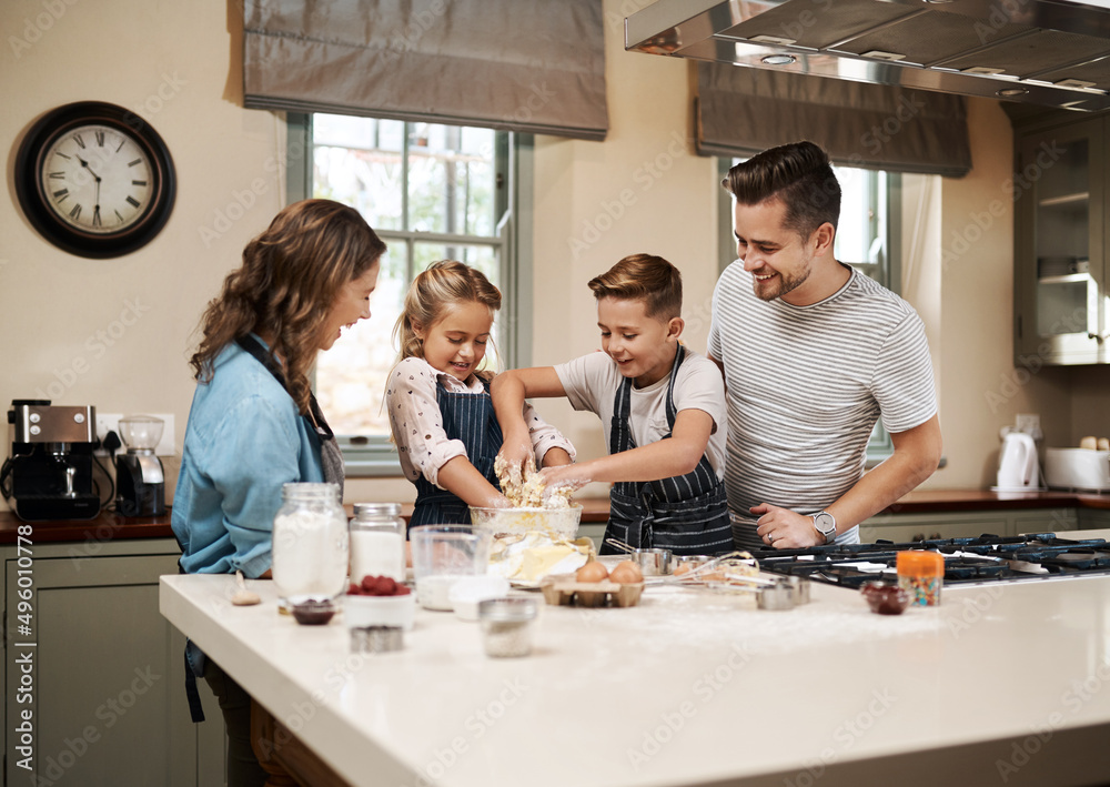 Wall mural Nothing tastes as good as something prepared by the whole family. Cropped shot of a young family baking in the kitchen at home.