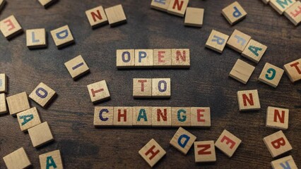 Phrase OPEN TO CHANGE made of wooden blocks with letters concept . High quality 4k footage - Powered by Adobe