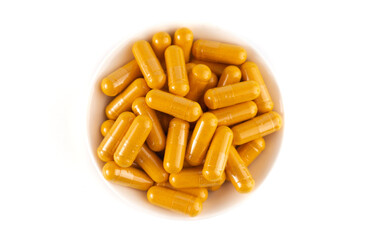 Ground Turmeric in Capsule form on a White Background