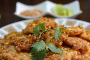 Corn Fritters With chili sauce placed on a wooden table