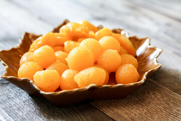 Thai Desserts :  Drops of gold and Jackfruit seed on leaf-shaped plates.