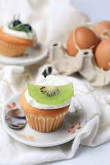 Kiwi cupcake with butter cream. Sweets or Cupcake with Topping. Birthday Confectionery Dessert, Pies, Pastry, Bakery or Patisserie Production