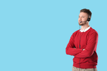 Handsome consultant of call center in headset on blue background