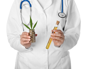 Laboratory worker with hemp oil in test tube and seeds in bottle on white background, closeup